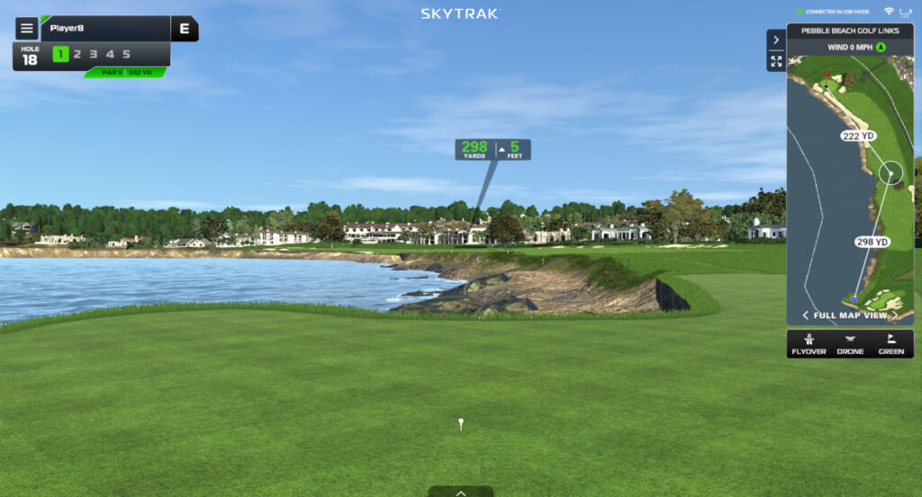 Coastal course rendered inside the simulator with ball flight tracer and shot data overlay